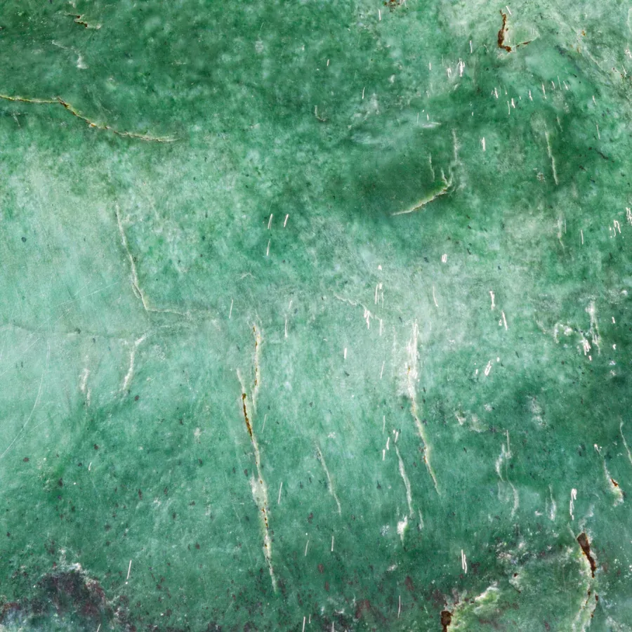 Jade stone, polished, showing its veins.